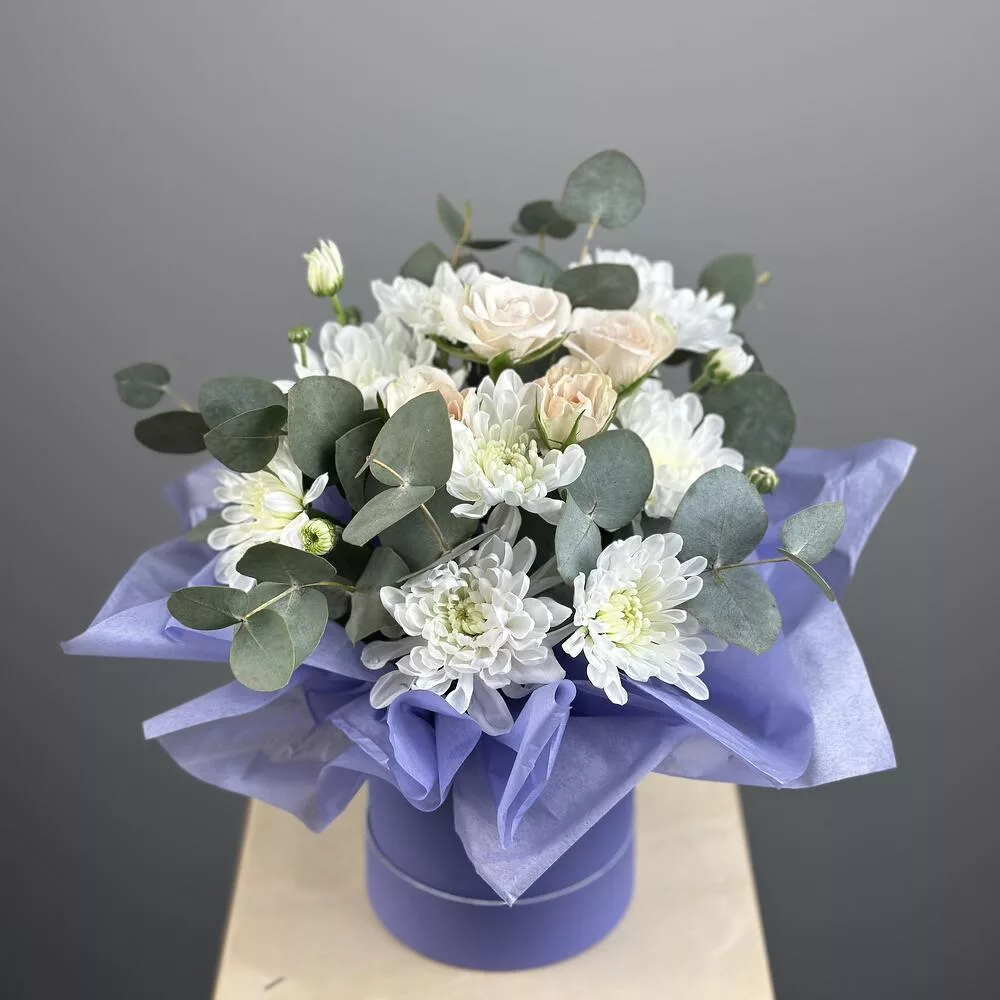 Flowers in a box spray roses and chrysanthemums with eucalyptus